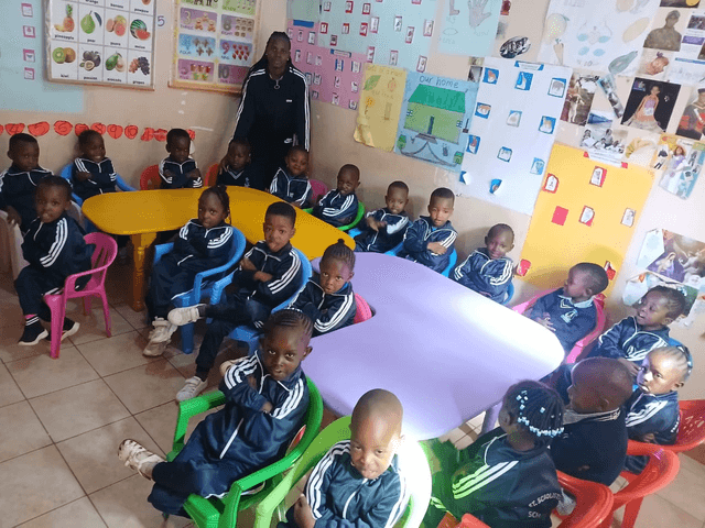 Children and their teacher in a St. Scholastica classroom